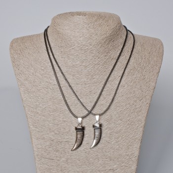 Twin pendants 'Fang' with black enamel and silvery metal, 35×12 mm; length 45–50 cm