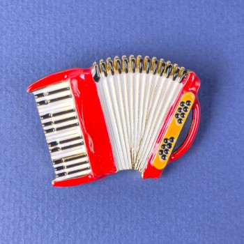 Brooch 'Accordion' red, white and black enamel on golden metal 42×31 mm+