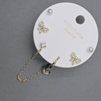 Gold-tone stud earrings with ear cuff and white crystals