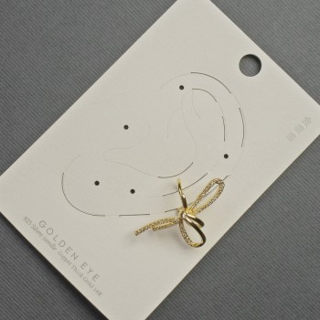 Ear cuff 'Bow' for the ear, gold-tone metal, 17×30 mm ± white crystals