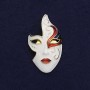 Mask Brooch with white, black, and red enamel on gold-tone metal, 40×23 mm, magnetic fastening