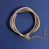 Triple bracelet in gold-tone, silver-tone, and gray metal with an extender chain