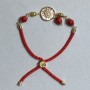 Textile bracelet, 5.5 mm diameter +/-, adjustable drawstring, coral faceted bead 8 mm +/-, with a gold-tone metal insert, 17 mm diameter +/-