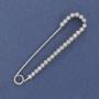 Brooch pin with white rhinestones 72x16 mm +/- silver metal
