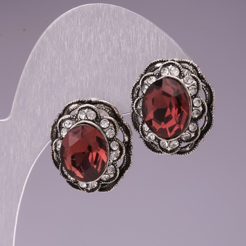 Stud earrings with pink oval crystals and a delicate filigree setting encrusted with rhinestones, 17 mm