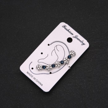 Silver-tone clip-on earring with blue rhinestones and white flowers