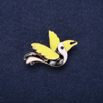 Bird-shaped enamel brooch in black, white, and green