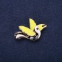 Bird-shaped enamel brooch in black, white, and green