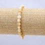 Elastic bracelet with natural beige mother-of-pearl. round beads, diameter 7×5 mm