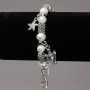 Elastic bracelet with freshwater pearls, silver inserts and pendants, diameter 8-10 mm, length 18 cm