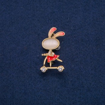 Brooch 'Bunny on a Scooter' with white crystals, gold-tone metal, red enamel, Cat's Eye cabochon (bijou) 43x21mm +