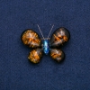 Butterfly Brooch in gold-tone metal with blue rhinestone and artificial dark amber, 50x35 mm +
