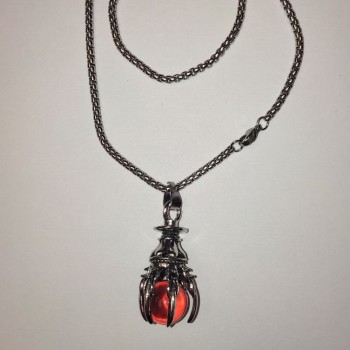 Pendant 'Ball in the Paw' orange 40x18 mm on a chain, length about 70 cm, silver-toned metal