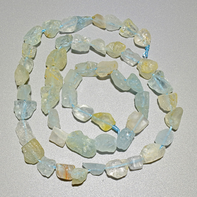 Beads of Rock Crystal and Aquamarine; natural untreated stone, haltivka shape, 6x8 mm diameter, about 40 cm long on a thread
