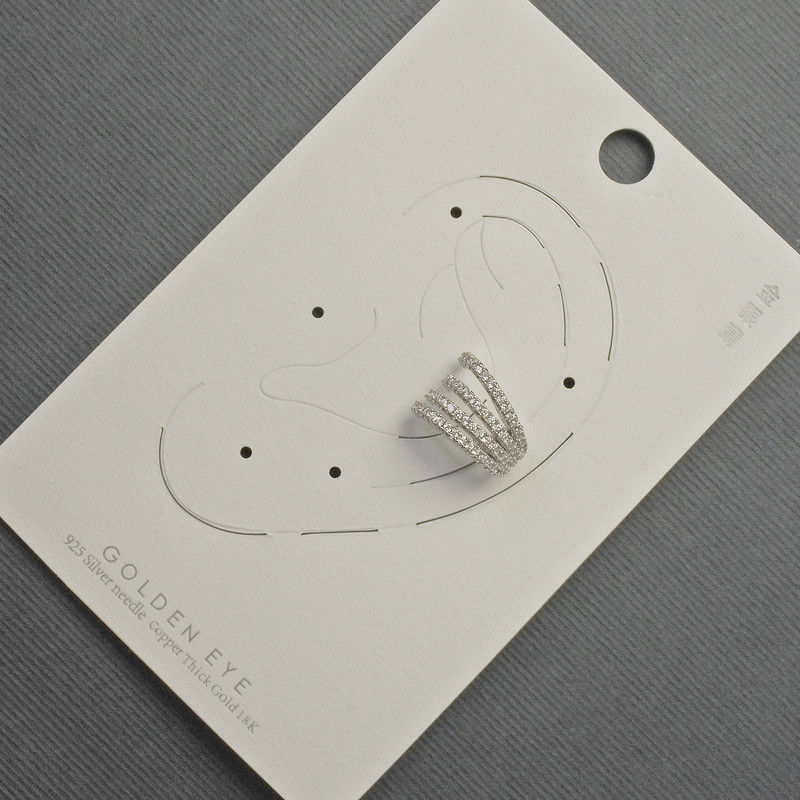 Ear cuff on the ear in silver-toned metal, 10x14 mm ±, with white rhinestones