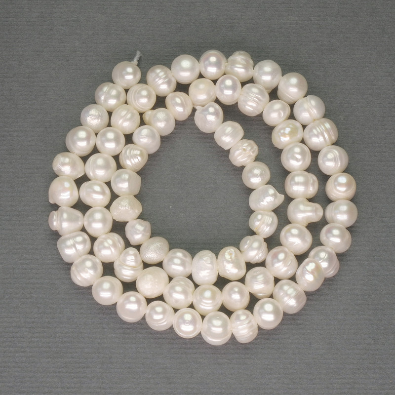 Freshwater white oval pearls on a thread, diameter approximately 5–6 mm, length 35 cm+