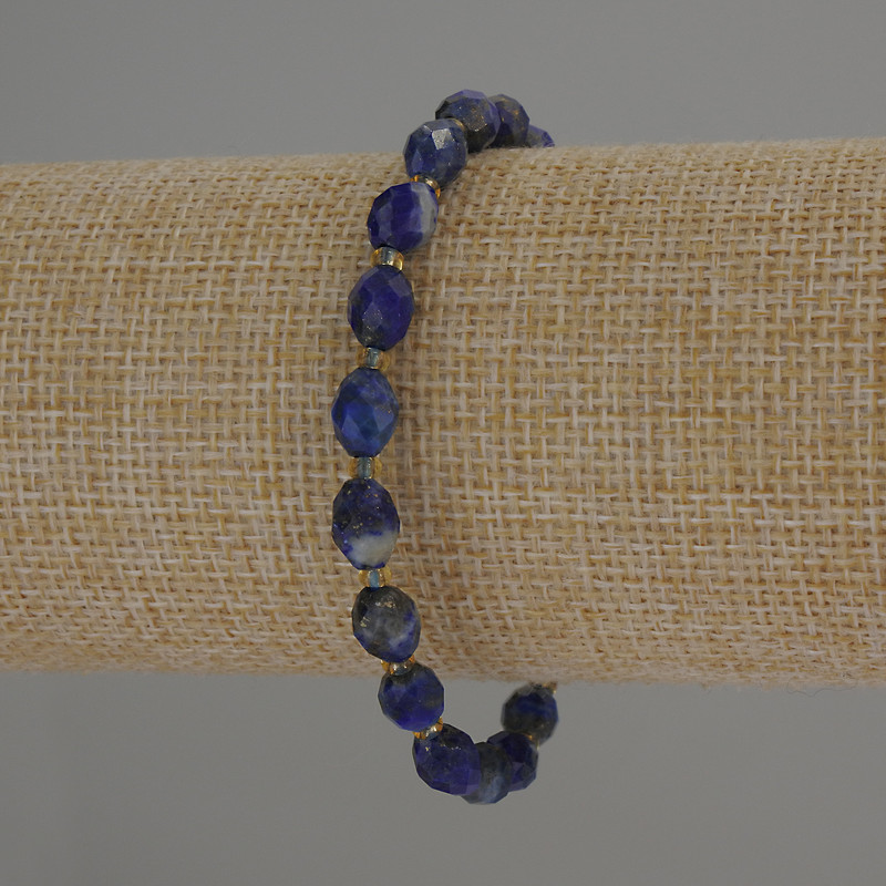 Bracelet with faceted lazurite beads, 8×6 mm diameter ± with 3 mm seed beads ±, 18 cm length, stretch