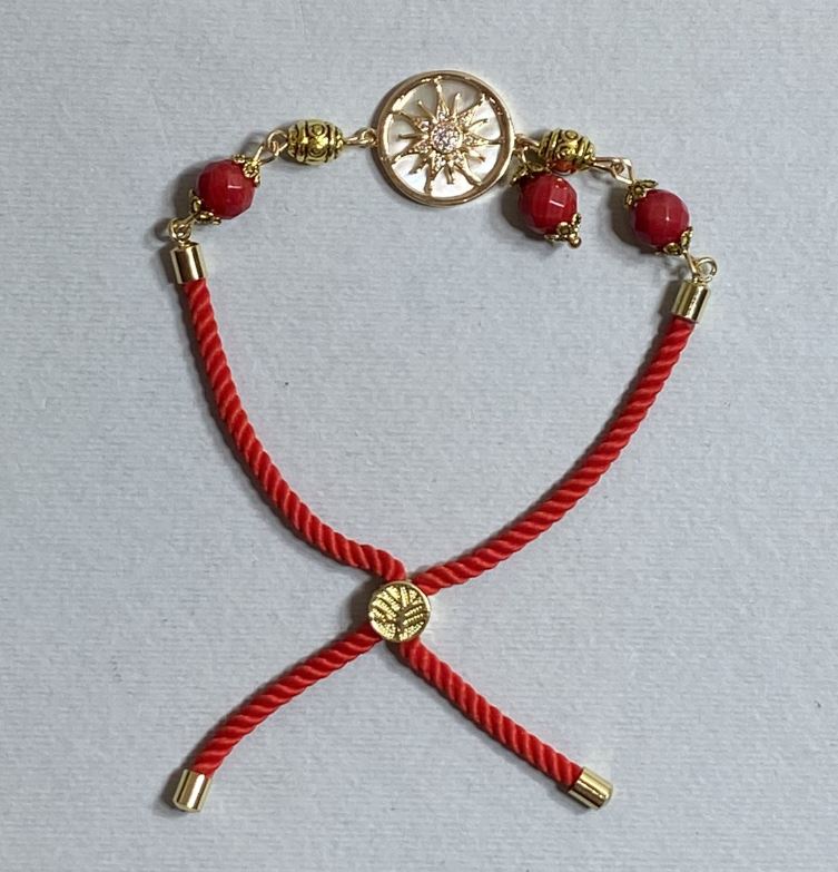 Textile bracelet, 5.5 mm diameter +/-, adjustable drawstring, coral faceted bead 8 mm +/-, with a gold-tone metal insert, 17 mm diameter +/-
