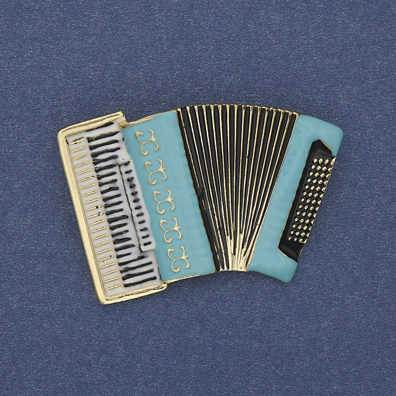 Brooch 'Accordion' blue and white enamel on gold-toned metal 43x28mm+