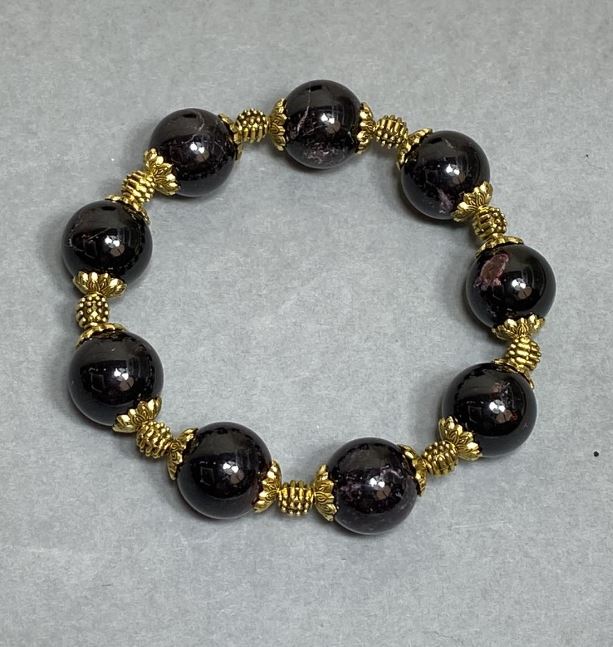 Garnet bracelet with smooth round beads 13 mm, metal inserts, length 18 cm ± stretch