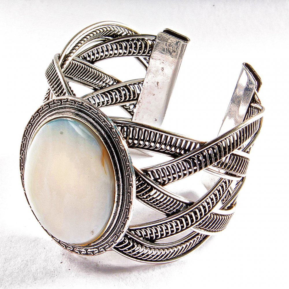 Wide mother-of-pearl bracelet in a metal bezel setting with Greek pattern, small oval