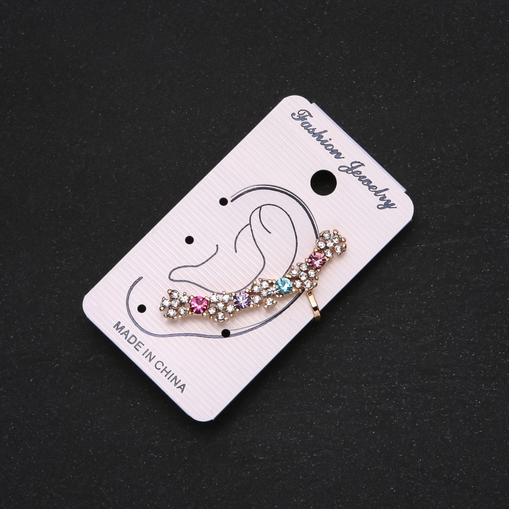 Gold-tone ear cuff with white flowers, multicolored crystals