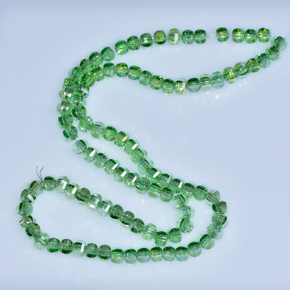 Crystal beads Swarovski style, light-green, faceted beads with 'gasoline' coating, 5×4 mm, 48 cm strand