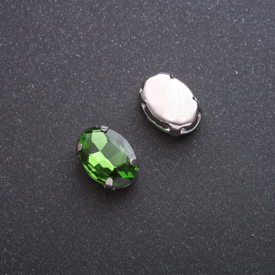 Price per pack: 10 pcs. Green oval sew-on crystal in prong setting, 10×14 mm
