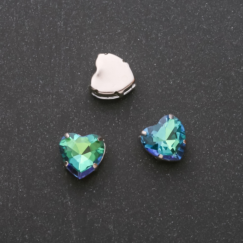 Price per pack / 10 pcs. Sew-on crystal in a heart-shaped prong setting, 10mm green-blue