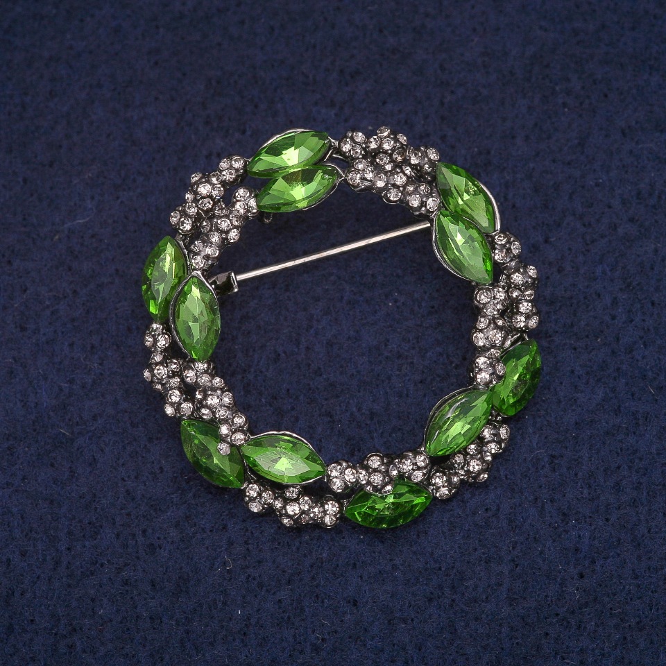 Brooch 'Wreath with green crystals and white rhinestones', gray metal 36x37 mm