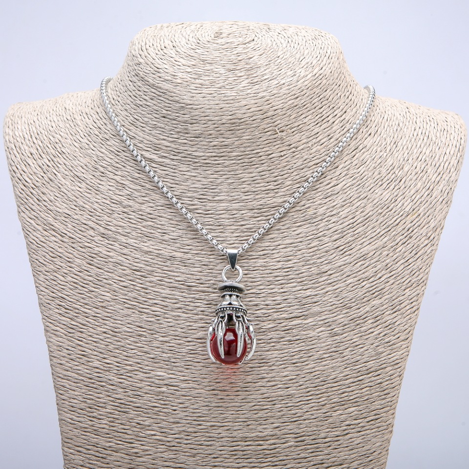 Pendant 'Ball in the Paw', red, 45×17 mm on a chain, length about 70 cm, silver-tone metal