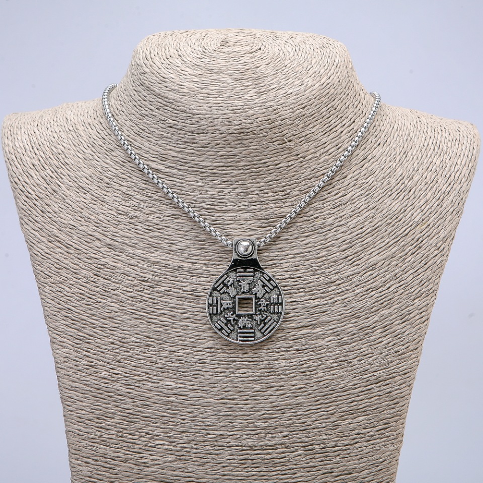 Pendant 43x30 mm on a chain, length about 70 cm; silver-colored metal.