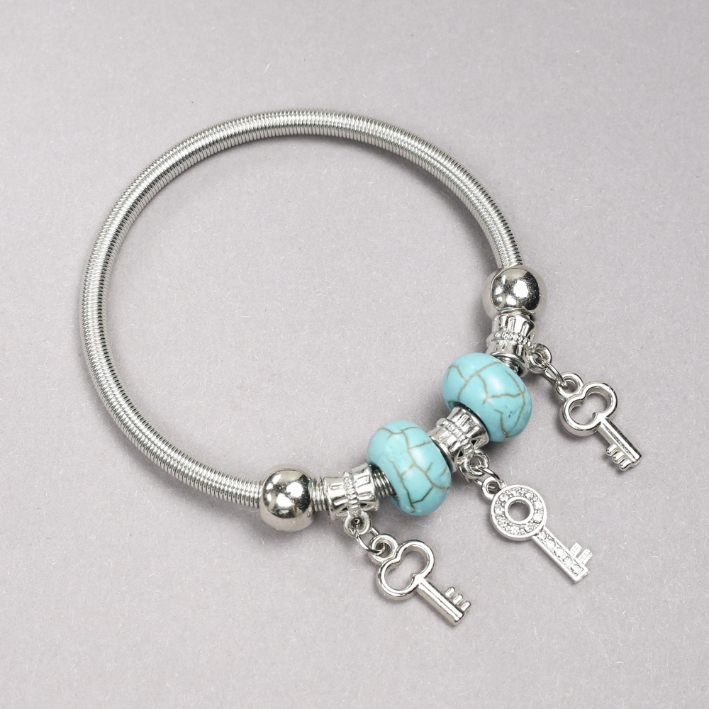 Pandora bracelet with turquoise beads (man-made), diameter 14x8 mm ±, and key-shaped pendants with white crystals