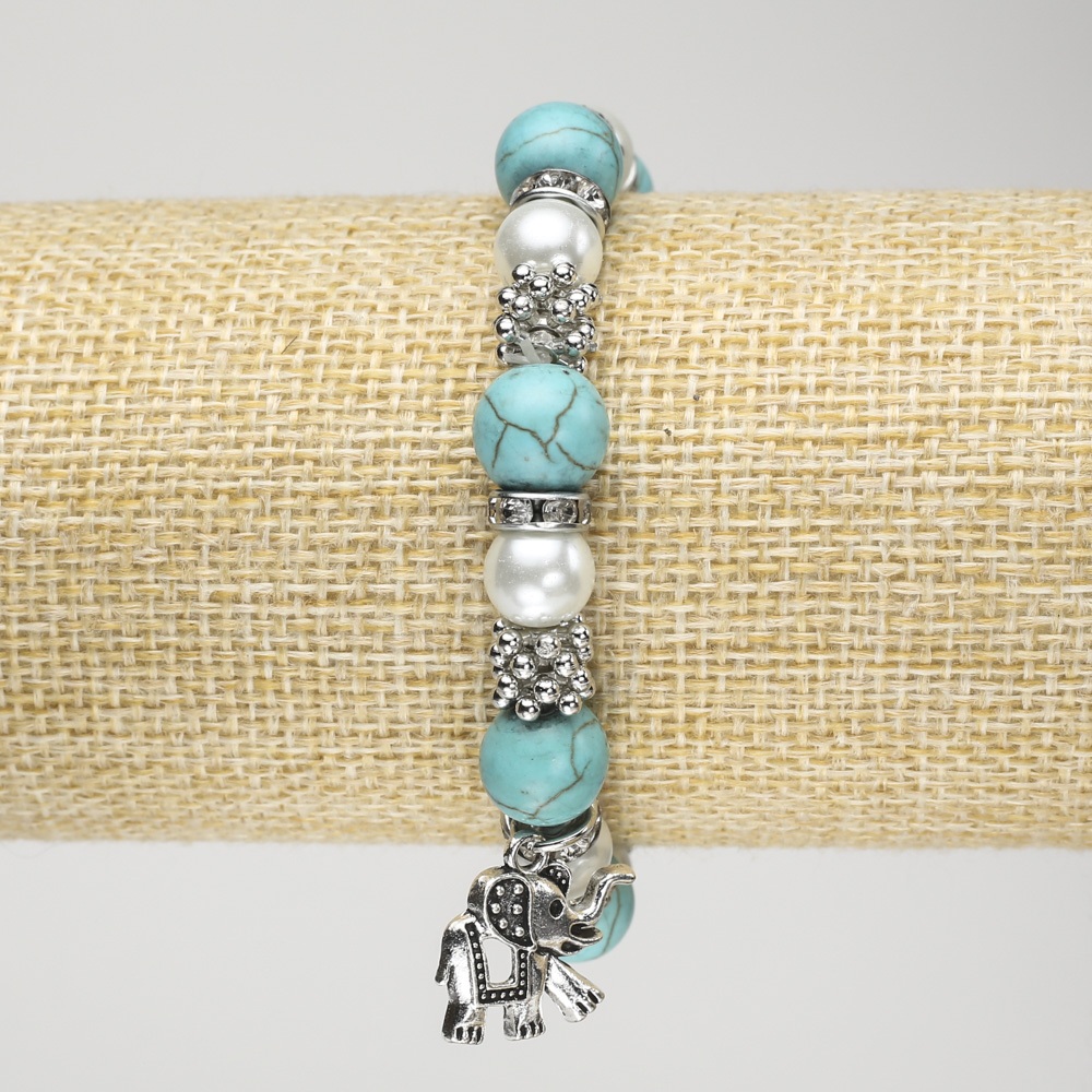 Turquoise Bead Bracelet (elastic) with 10 mm diameter ±, featuring artificial pearls, silver-tone inserts, and Elephant pendant, length 18 cm+