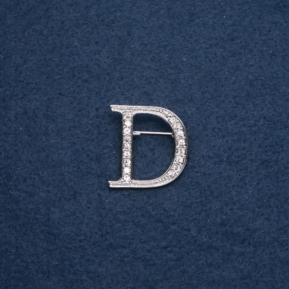 Brooch with initial letter 'D' 30x28mm, metal color 'silver'
