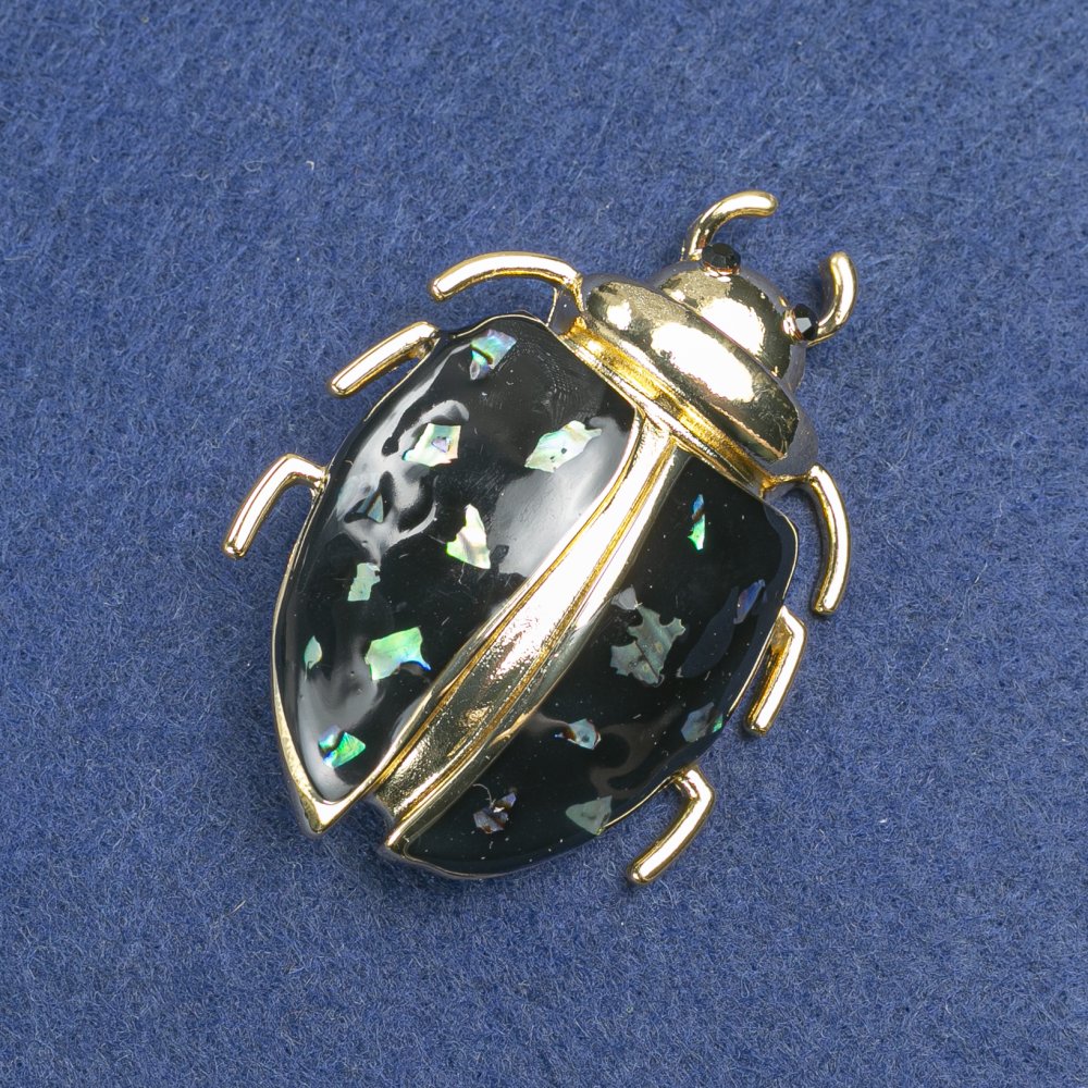 Brooch 'Bug' with golden metal, black enamel, abalone and black rhinestones, 58x24 mm +