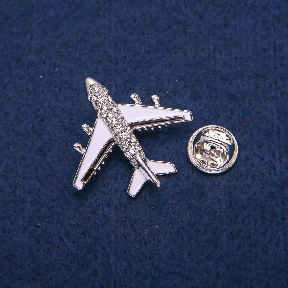 Brooch Airplane with white and black enamel, crystals, silver-toned metal 29x30mm