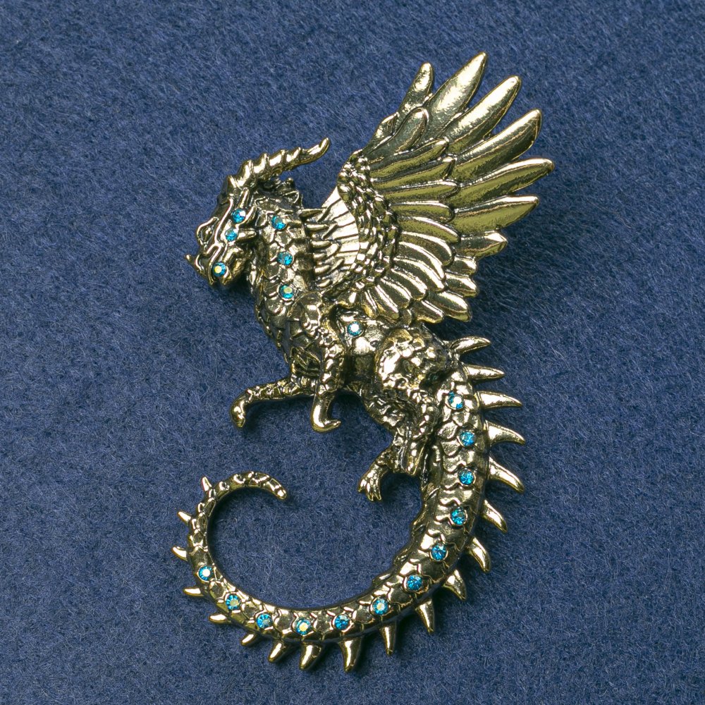 Brooch Dragon, gold-toned metal with blue petrol crystals 64×50 mm+