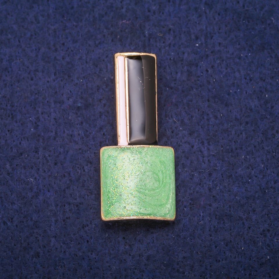 Brooch 'Lac' green, black and white enamel on gold-tone metal 18x39mm