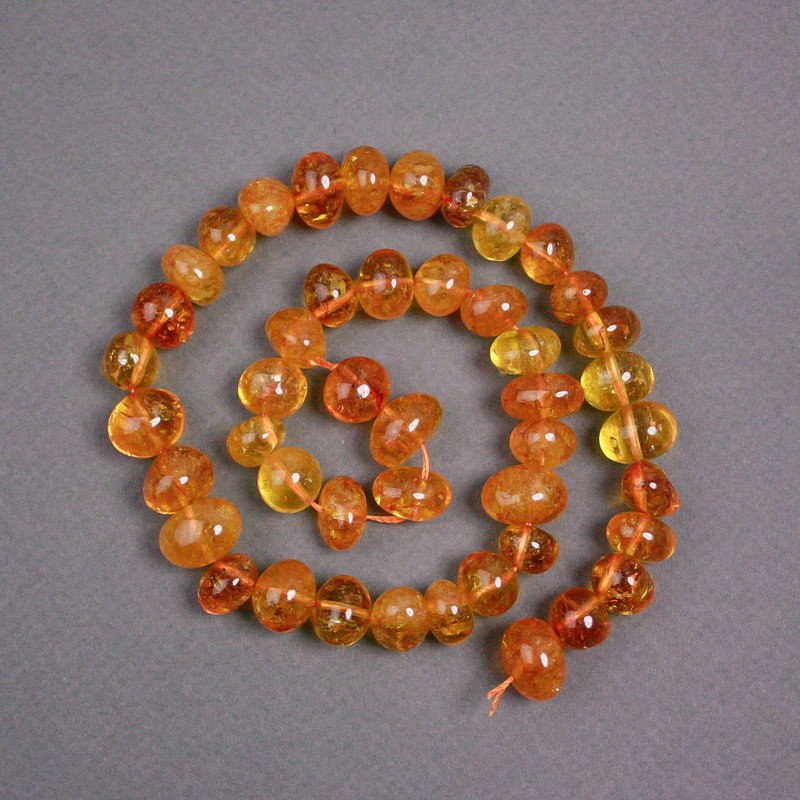 Orange rock crystal beads, amber-toned, coin-shaped, 12x9 mm, 40 cm length